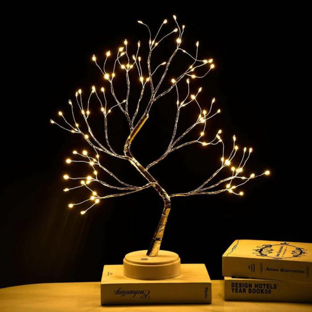 cordless fairy light tree sitting on books