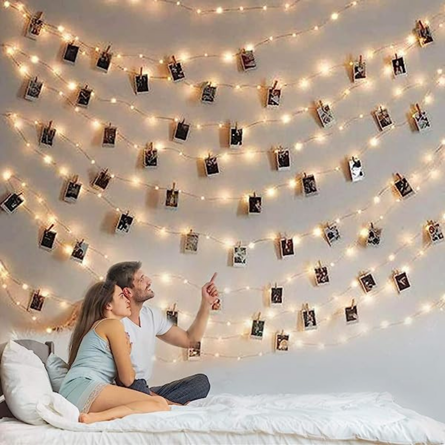 Photo Clip String Lights over a bed with a couple on the bed