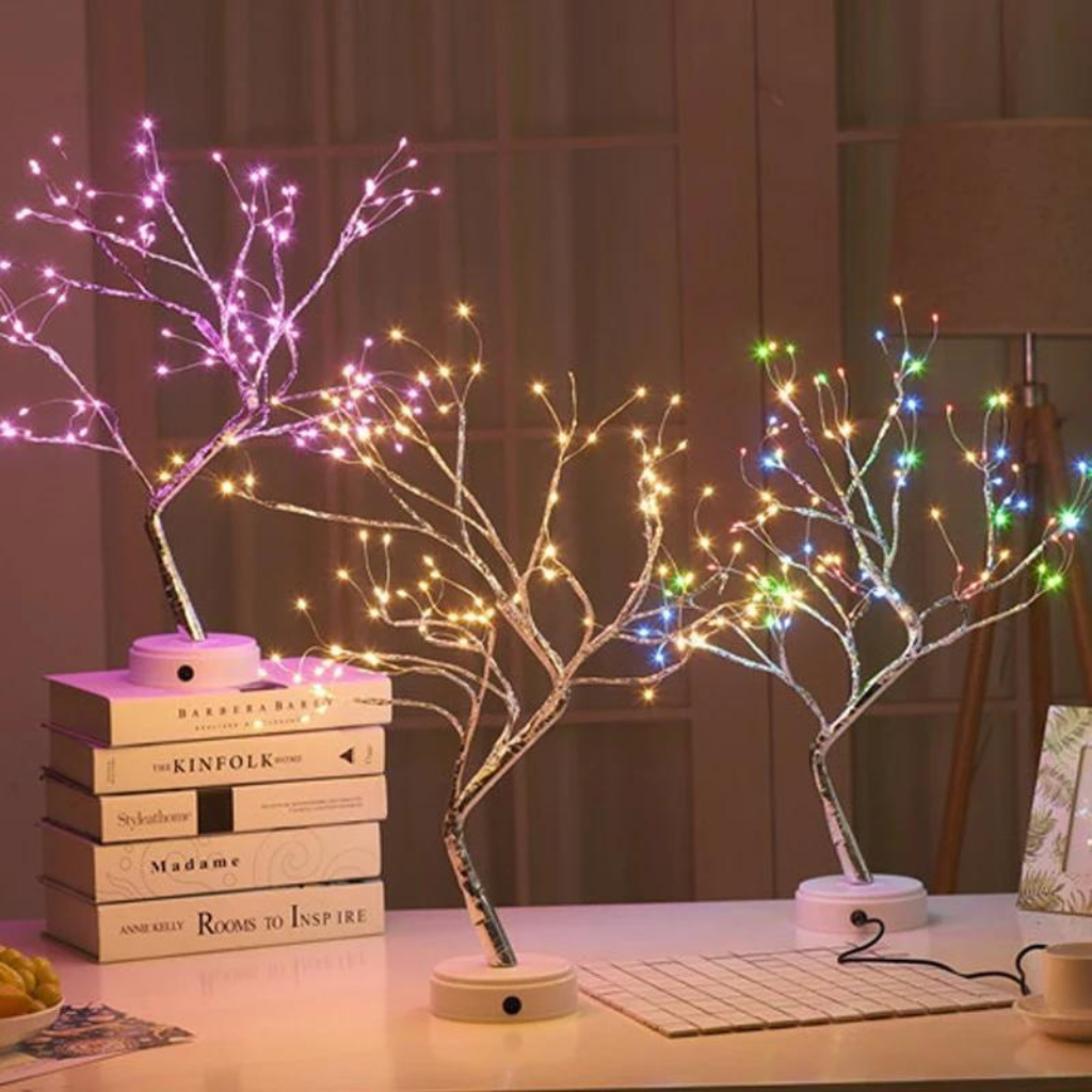 cordless colorful fairy light tree sitting on books