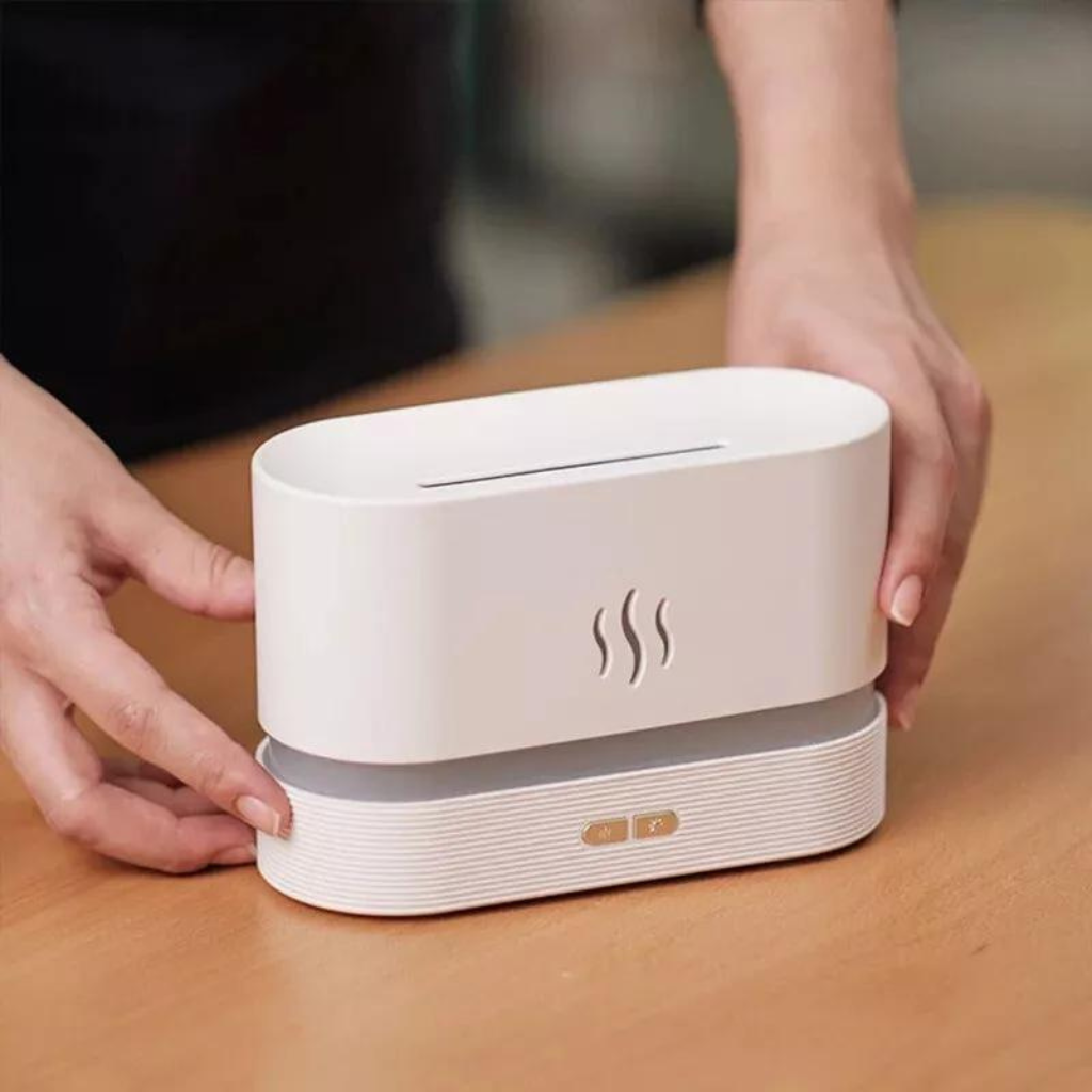 hands holding a White aroma diffuser 